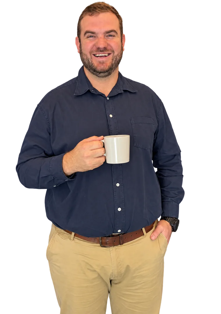 Andre Schwab smiling, holding a coffee mug